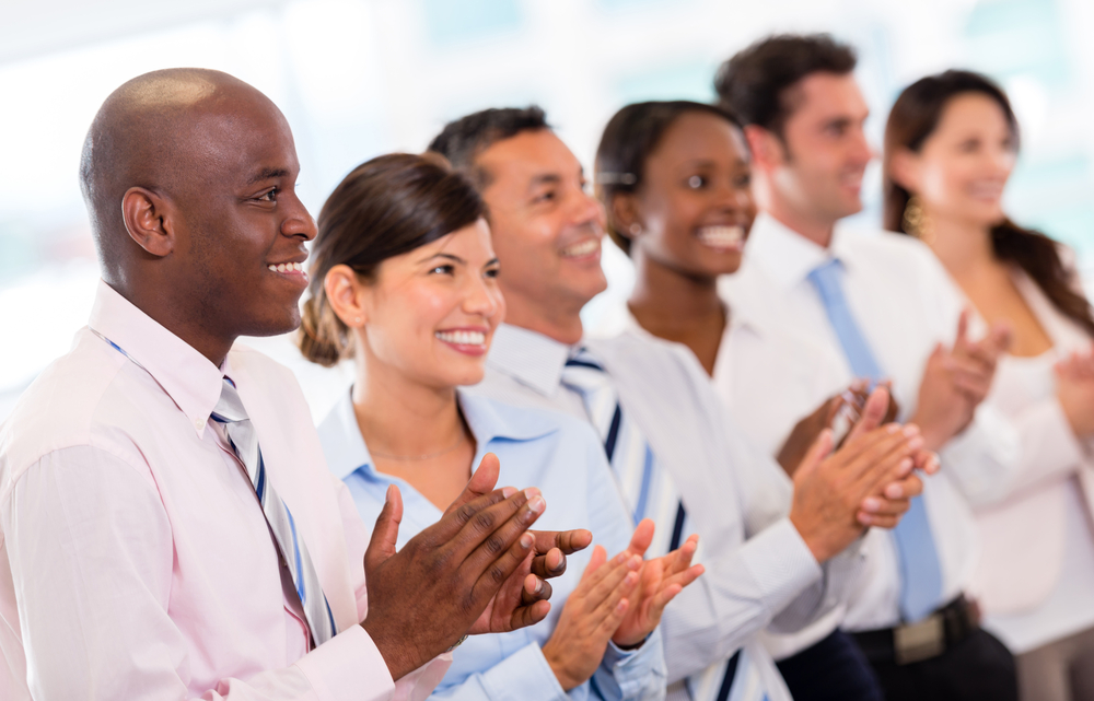E Successful business presentation and a group of people applauding